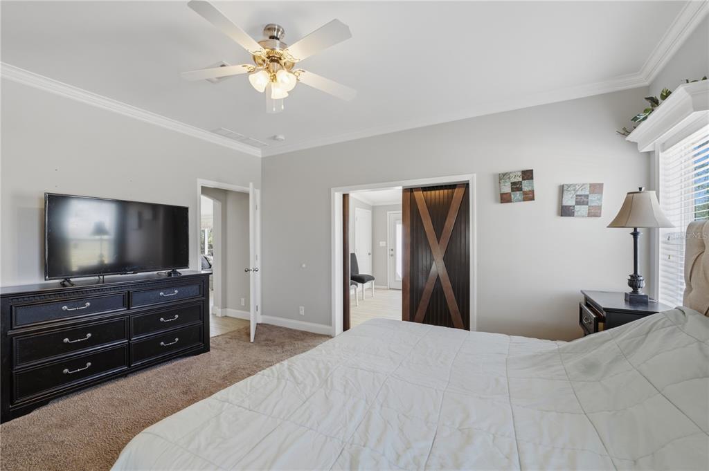 6844 Chad Jason Road St. Cloud, FL 34773 - Photo 32 of 59 a bedroom with a bed and a flat screen tv
