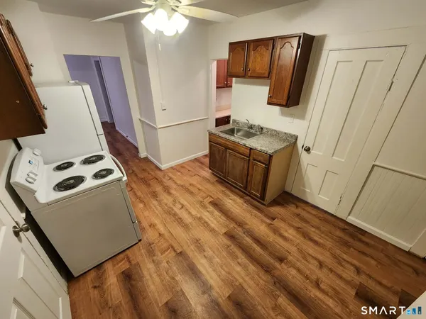 a kitchen with sink microwave and refrigerator
