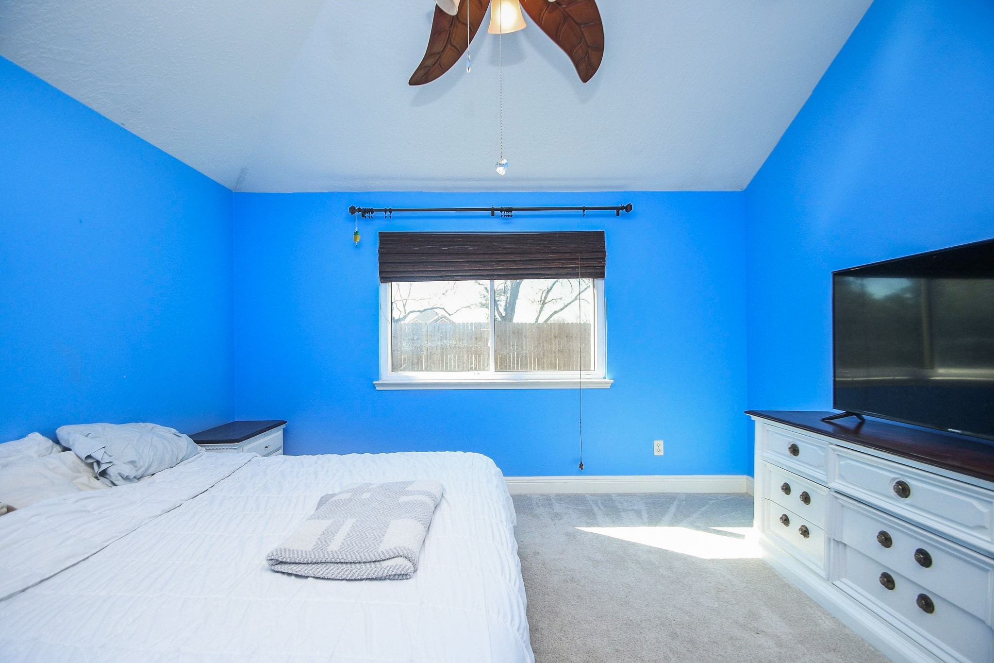 10823 Windswept Montgomery, TX 77356 - Photo 16 of 32 a bedroom with a bed and a flat screen tv