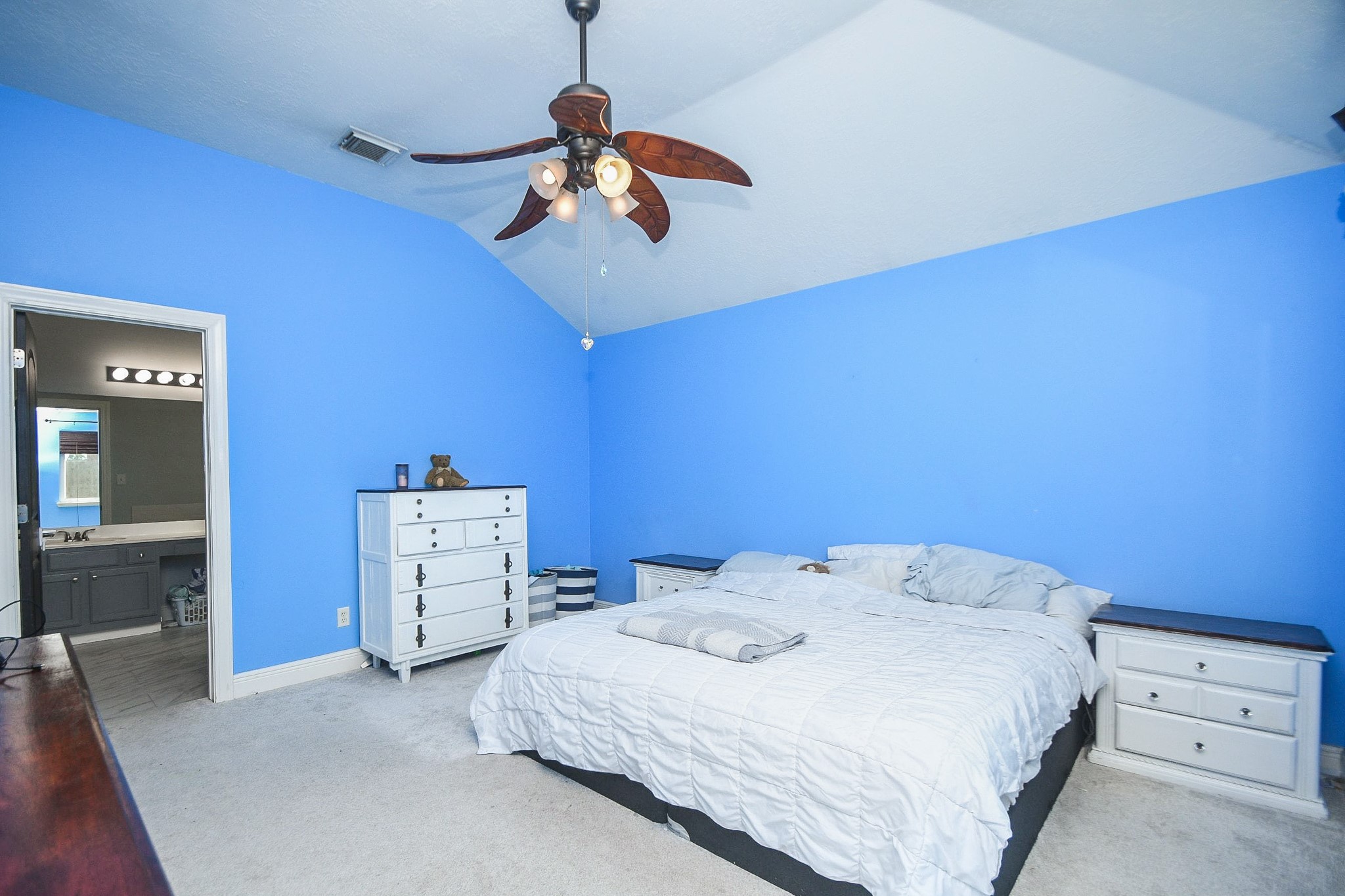 10823 Windswept Montgomery, TX 77356 - Photo 17 of 32 a bedroom with a bed and a chandelier