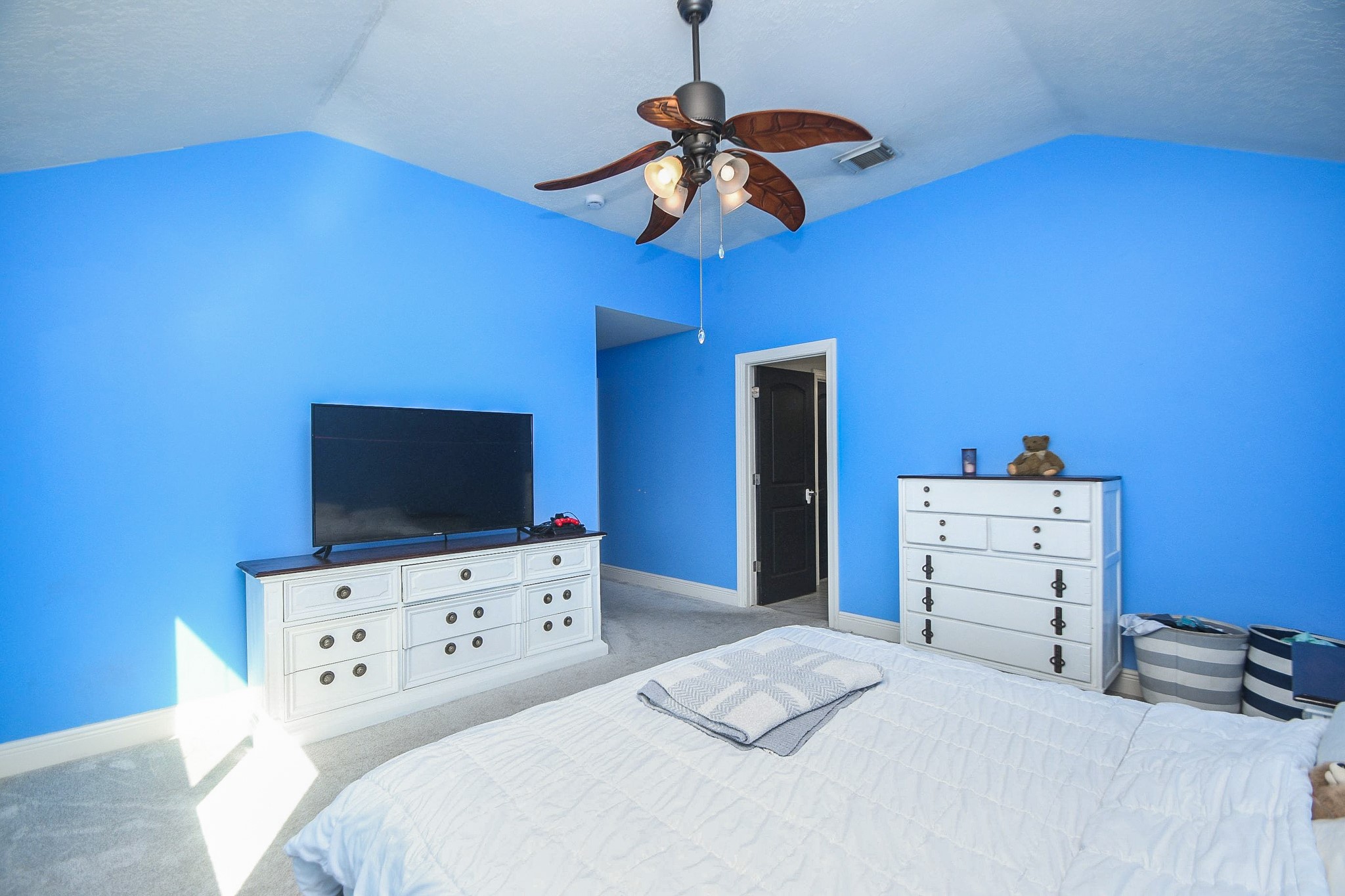 10823 Windswept Montgomery, TX 77356 - Photo 18 of 32 a bedroom with a bed and a flat screen tv