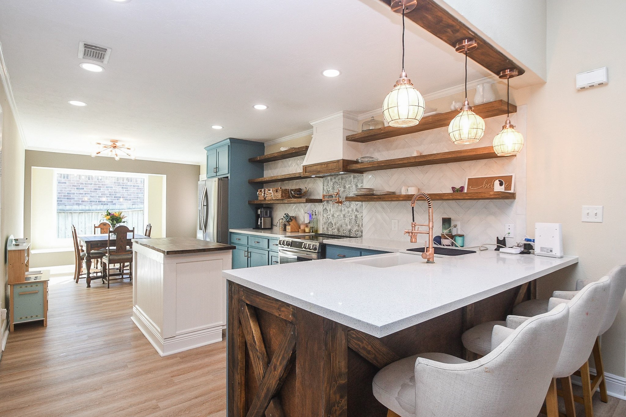 10823 Windswept Montgomery, TX 77356 - Photo 10 of 32 a kitchen with a table chairs stove and wooden floor