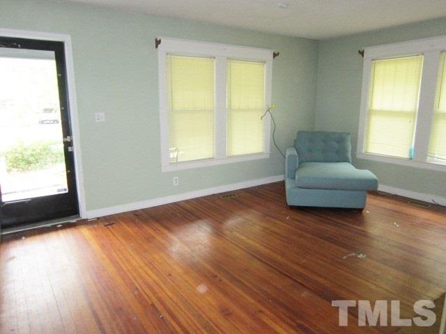 716 Crosby Road Durham, NC 27704 - Photo 4 of 17 a living room with wooden floors and a window