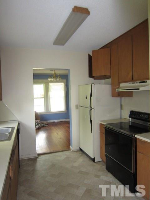 716 Crosby Road Durham, NC 27704 - Photo 9 of 17 a kitchen with a stove and a refrigerator