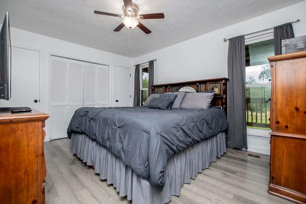 323 Newman Road Franklin, GA 30217 - Photo 12 of 47 a bedroom with bed a bed and a refrigerator