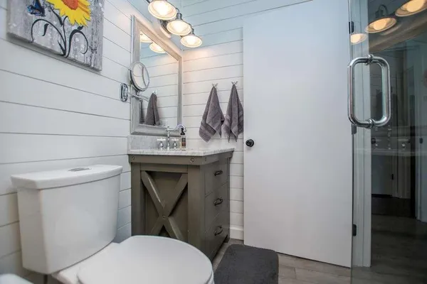 a bathroom with a toilet sink and mirror