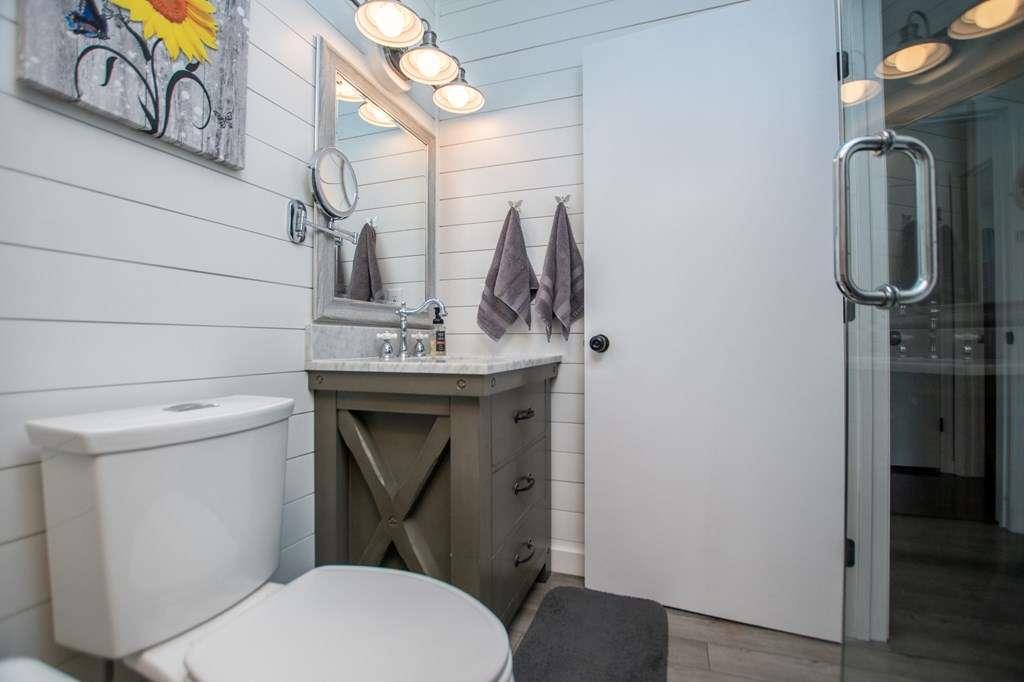 323 Newman Road Franklin, GA 30217 - Photo 14 of 47 a bathroom with a toilet sink and mirror
