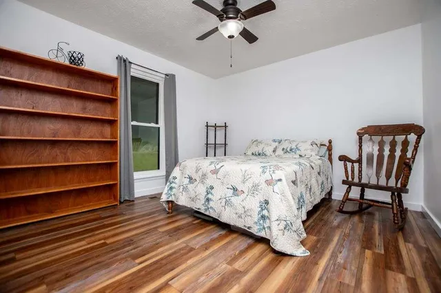 a bedroom with a bed and a chair