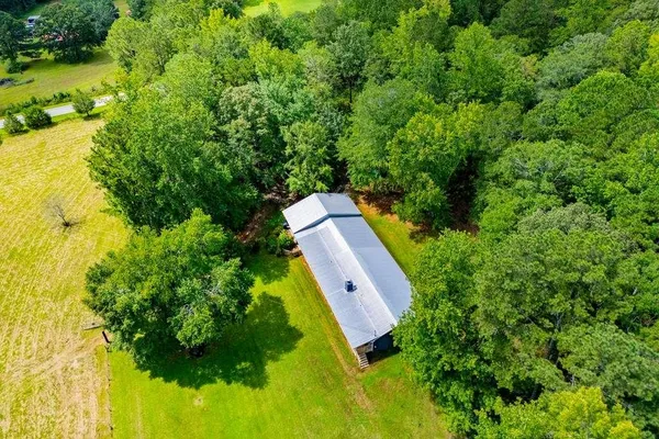 an aerial view of a house with a yard