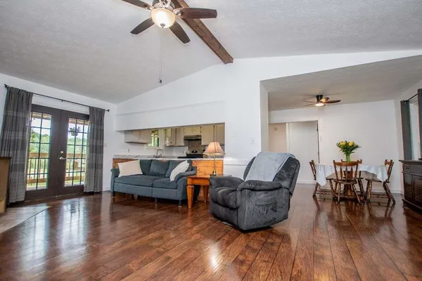 a living room with furniture and a wooden floor