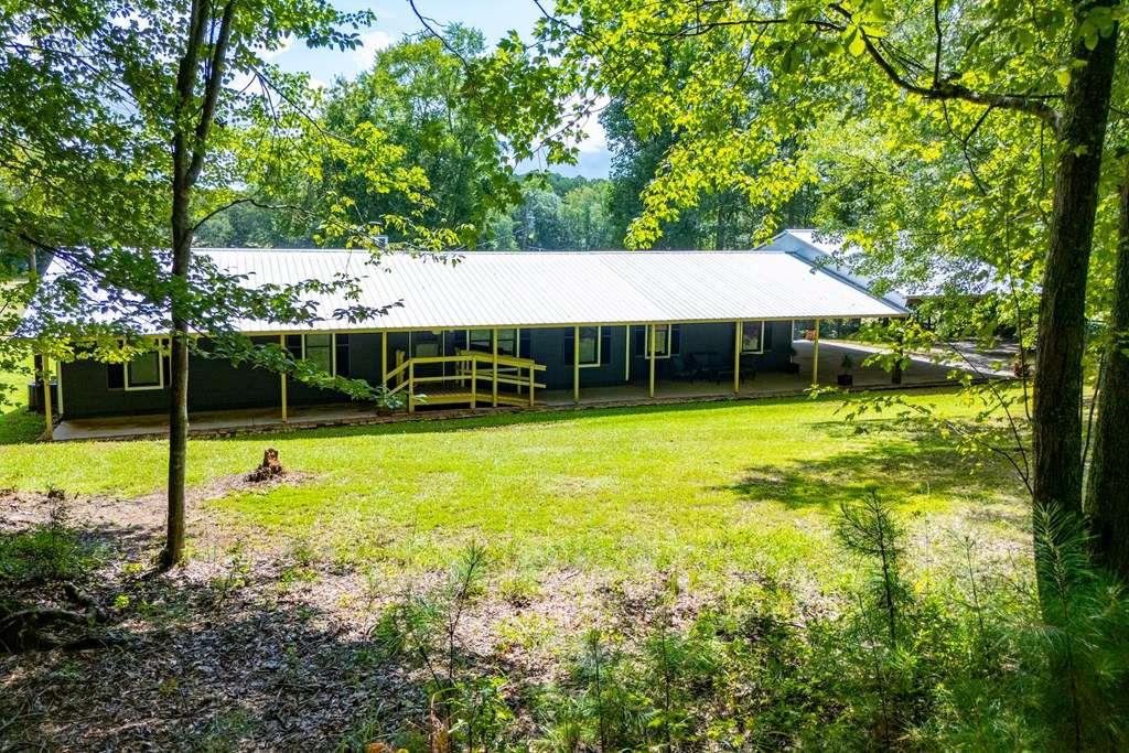 323 Newman Road Franklin, GA 30217 - Photo 36 of 47 a view of a house with a backyard and a patio