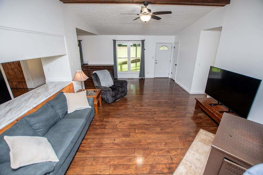 323 Newman Road Franklin, GA 30217 - Photo 4 of 47 a living room with furniture and a flat screen tv