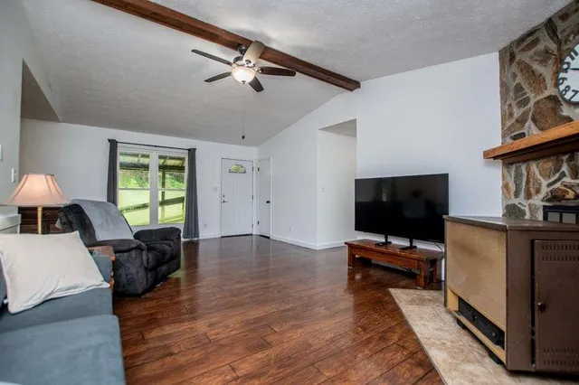 a living room with furniture and a flat screen tv