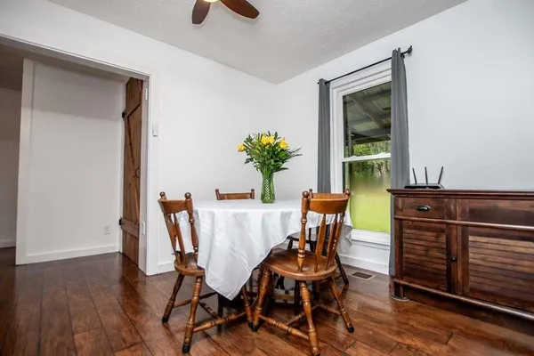 a view of a dining room with furniture and a potted plant