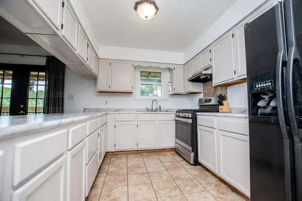 a kitchen with stainless steel appliances granite countertop a sink and cabinets