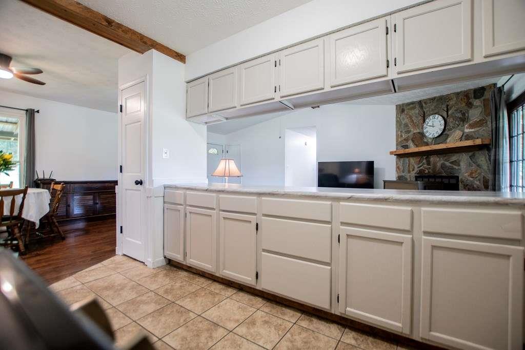 323 Newman Road Franklin, GA 30217 - Photo 10 of 47 a kitchen with white cabinets and sink