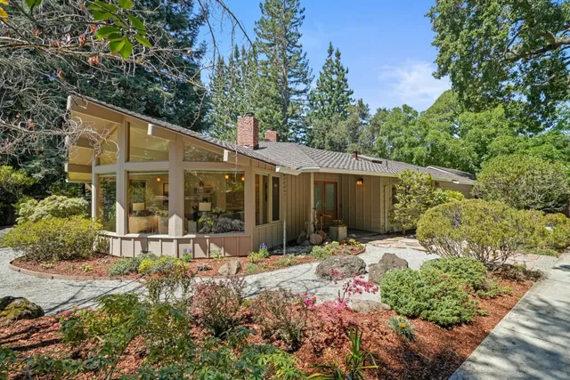 a view of a house with yard and sitting area