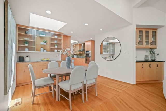 a dining room with furniture a window and wooden floor