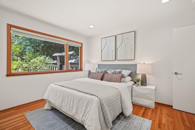 a bedroom with a bed and a large window