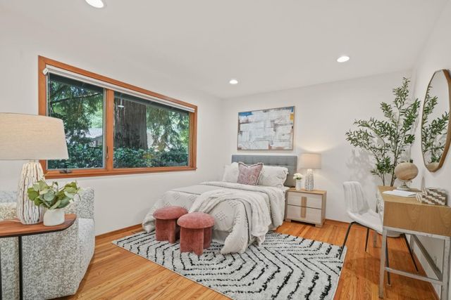 a bedroom with furniture and a large window