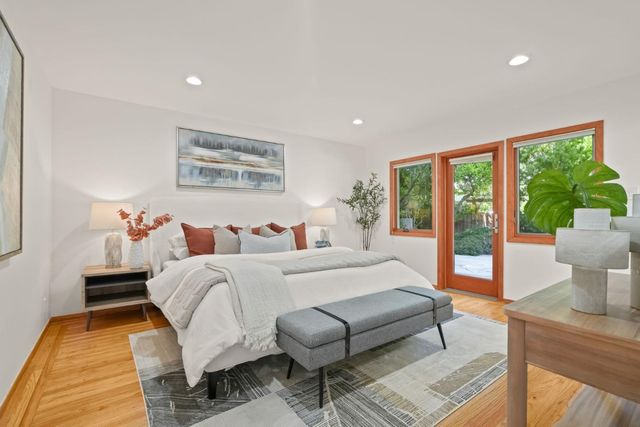 a spacious bedroom with a large bed and a large window