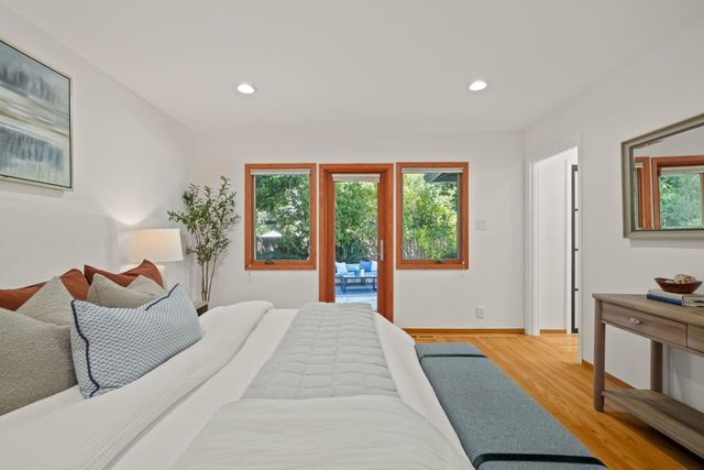 a spacious bedroom with a large bed and a window