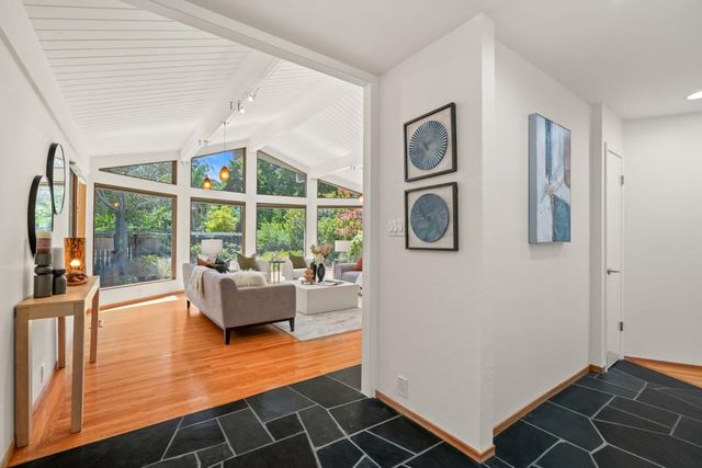 a living room with furniture and large windows