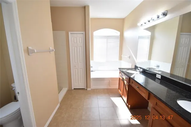 a large kitchen with a sink and a stove top oven