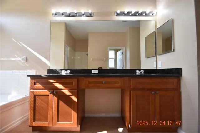 a bathroom with a sink mirror and vanity