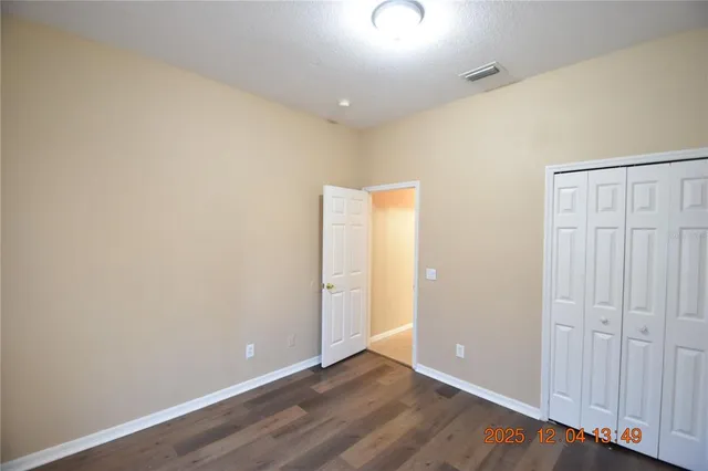 an empty room with wooden floor