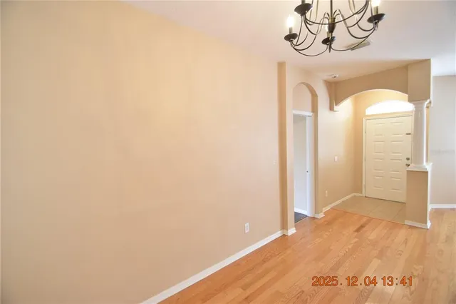 a view of a room with wooden floor