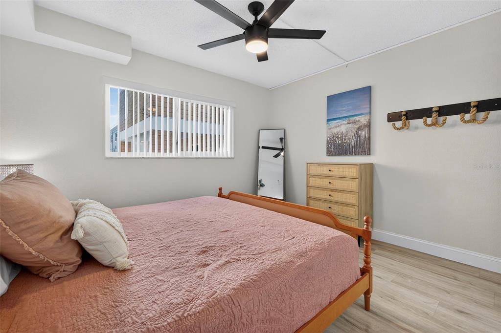 14251 Gulf Boulevard, Unit 5 Madeira Beach, FL 33708 - Photo 13 of 18 a bedroom with a bed and a window