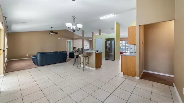 a view of a kitchen with furniture and a refrigerator
