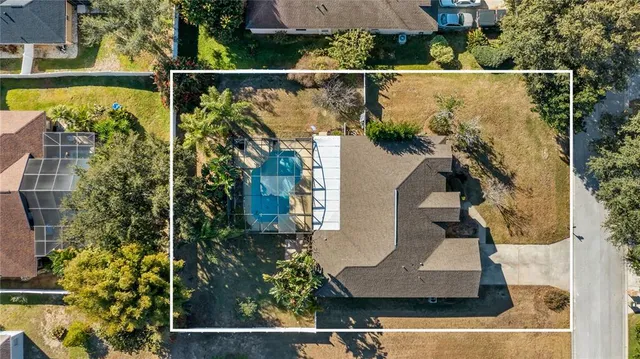 an aerial view of residential houses with outdoor space and street view