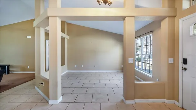 a view of a hallway with bathroom and front door