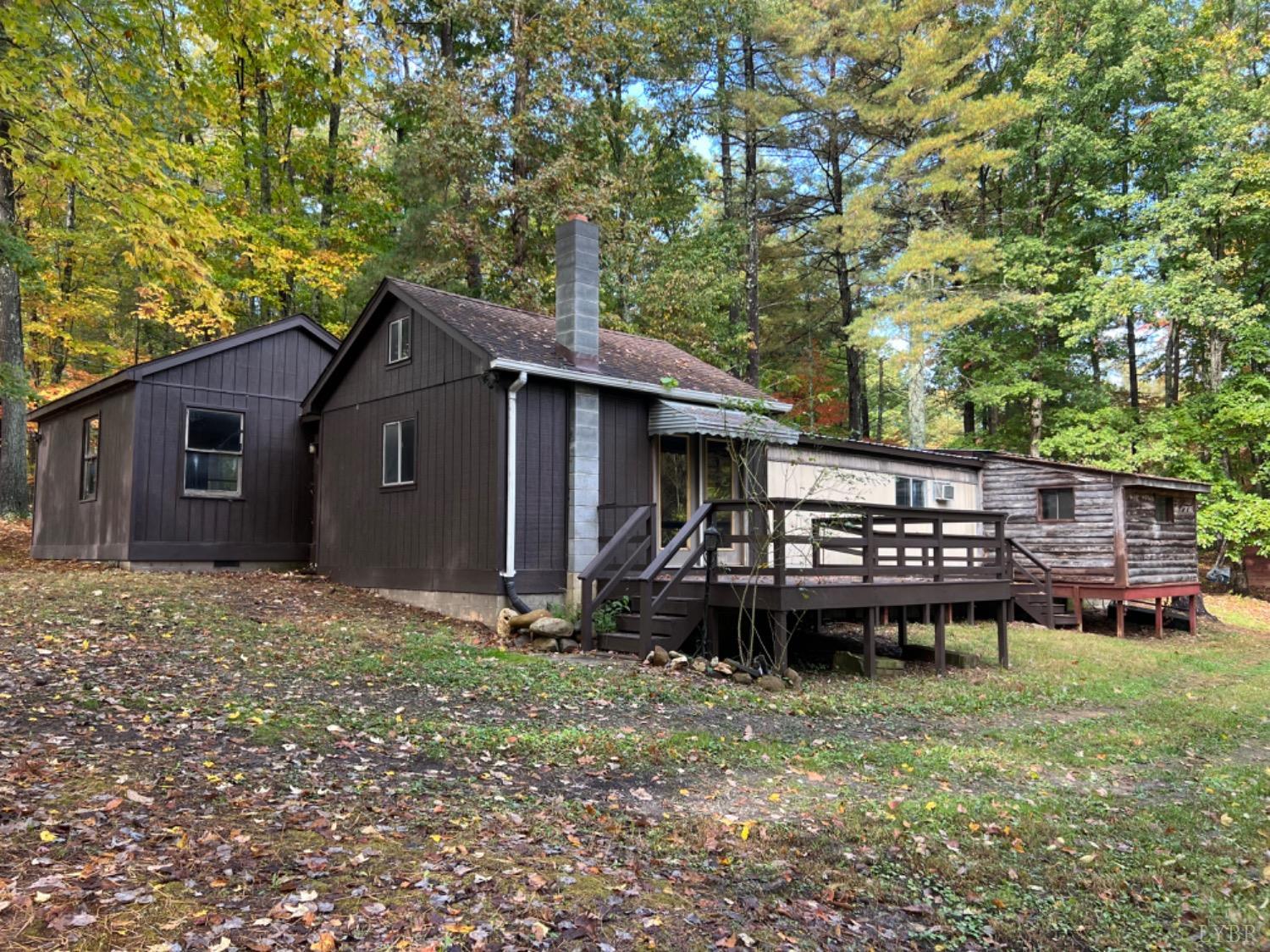 157 White Pine Drive Monroe, VA 24574 - Photo 10 of 13 a backyard of a house with wooden fence and large trees