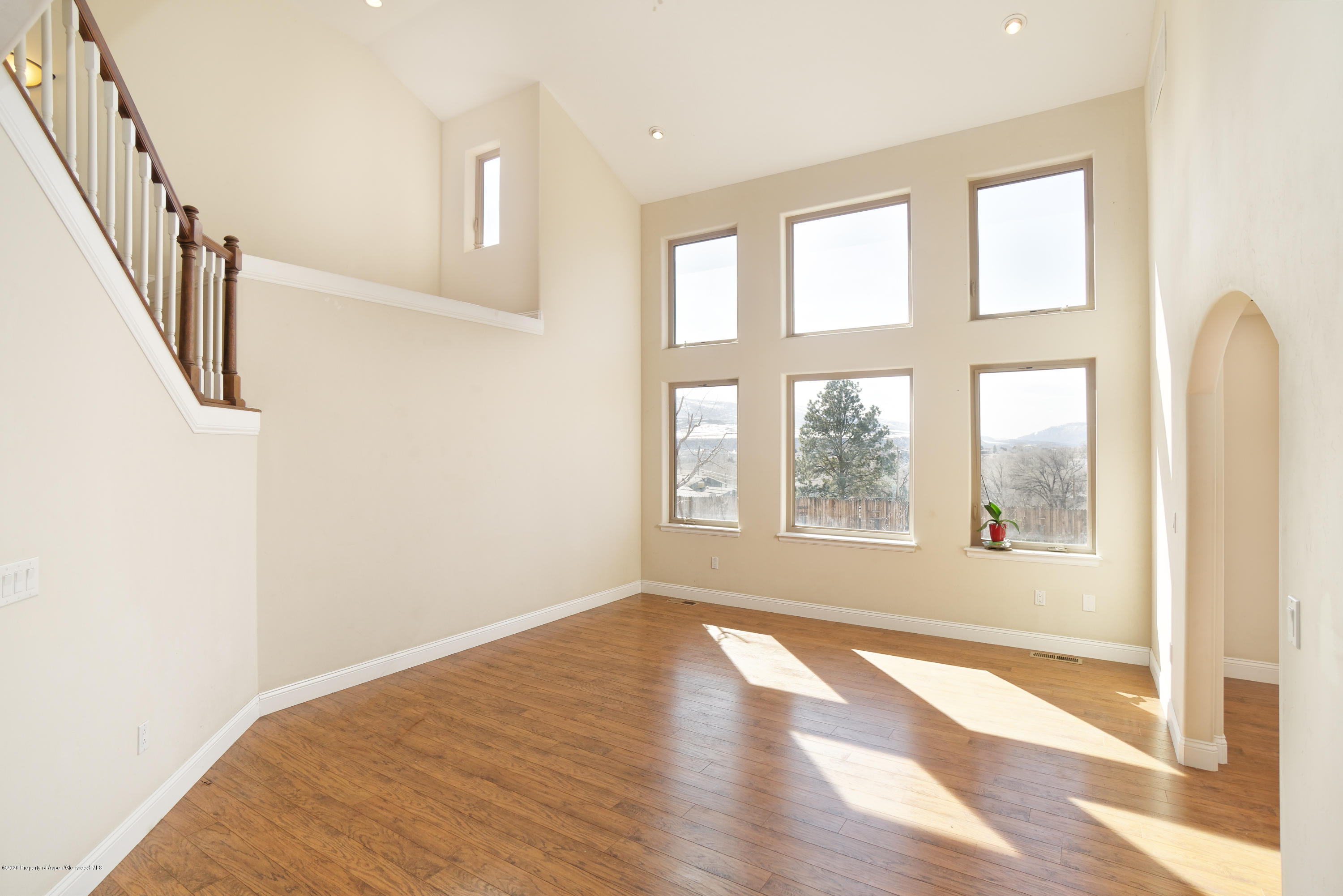 1339 Rifle Heights Drive Rifle, CO 81650 - Photo 5 of 22 a view of an empty room with wooden floor and a window