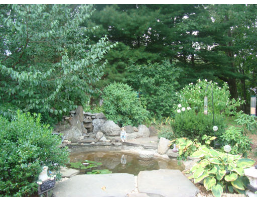 a view of a backyard with sitting area