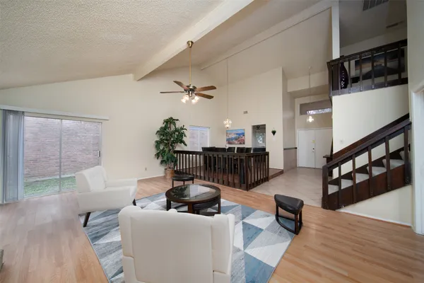 a living room with furniture and wooden floor