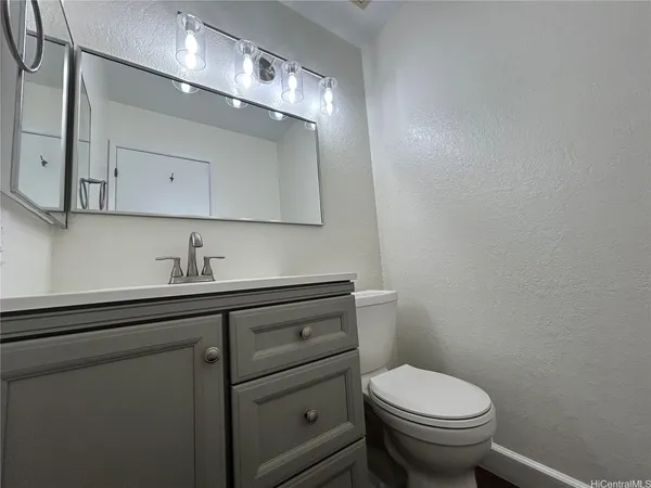 a bathroom with a sink a toilet and mirror