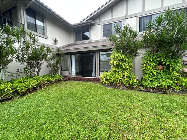 a view of a house with garden and plants