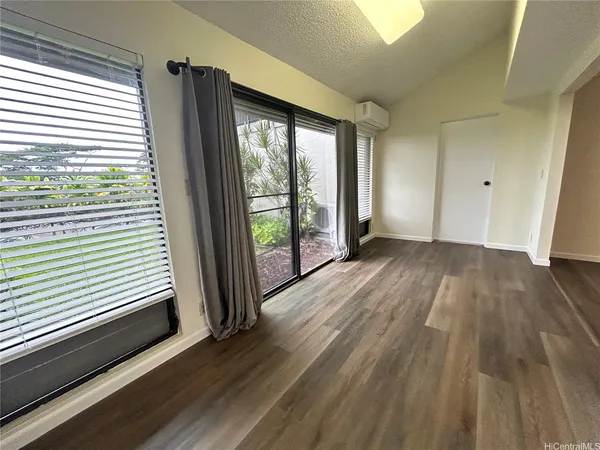 a view of a room with wooden floor and balcony