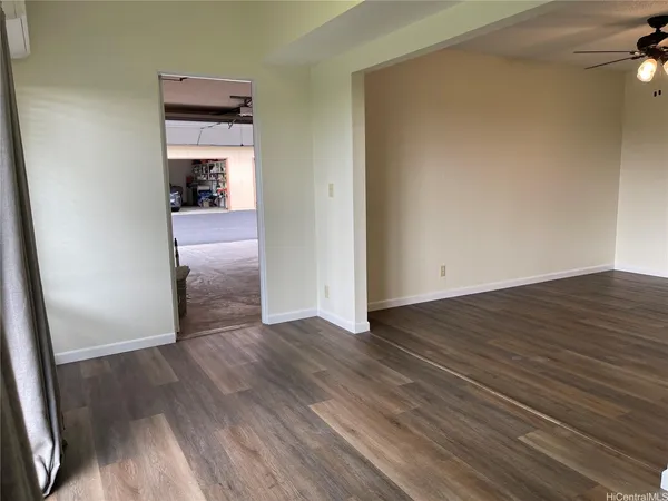 a view of a room with wooden floor