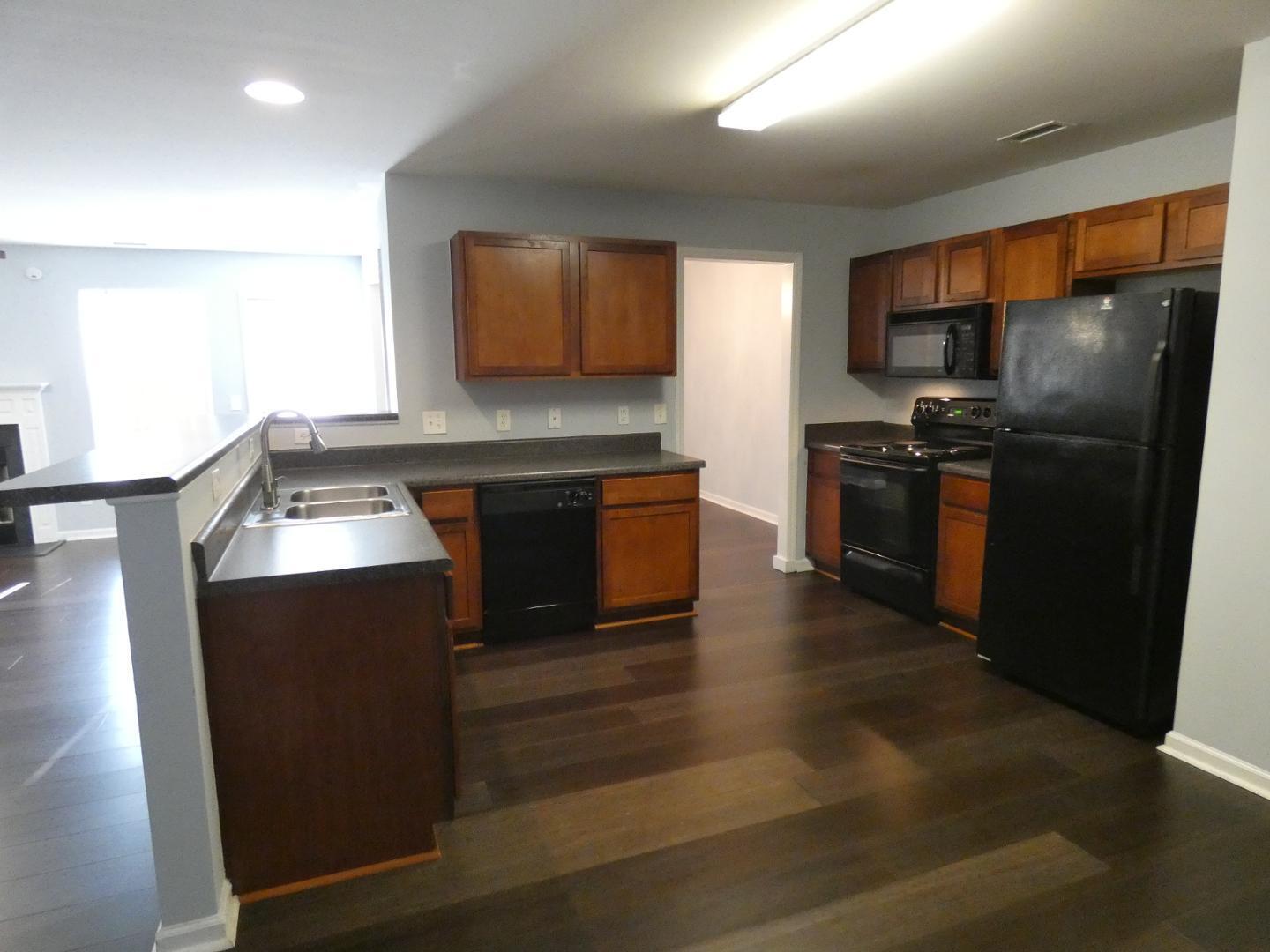1624 Brown Owl Drive Raleigh, NC 27610 - Photo 3 of 22 a kitchen with stainless steel appliances granite countertop a refrigerator a stove a sink and a microwave