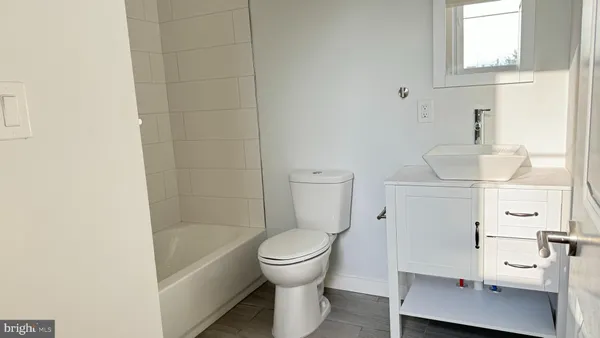 a bathroom with a sink a toilet and a bathtub