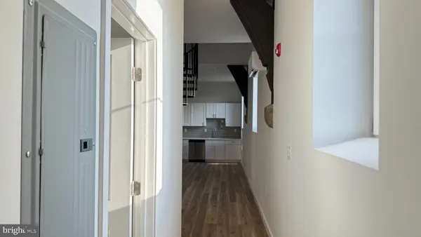 a view of hallway with wooden floor