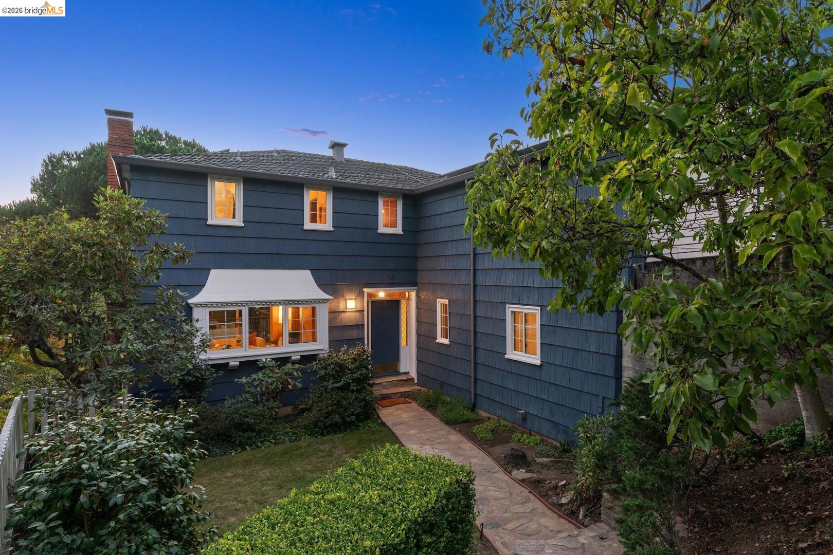 155 Avenida Drive Berkeley, CA 94708 - Photo 65 of 86 Two-story residence featuring blue siding, white trim windows, a prominent bay window, and a natural stone-paved walkway
