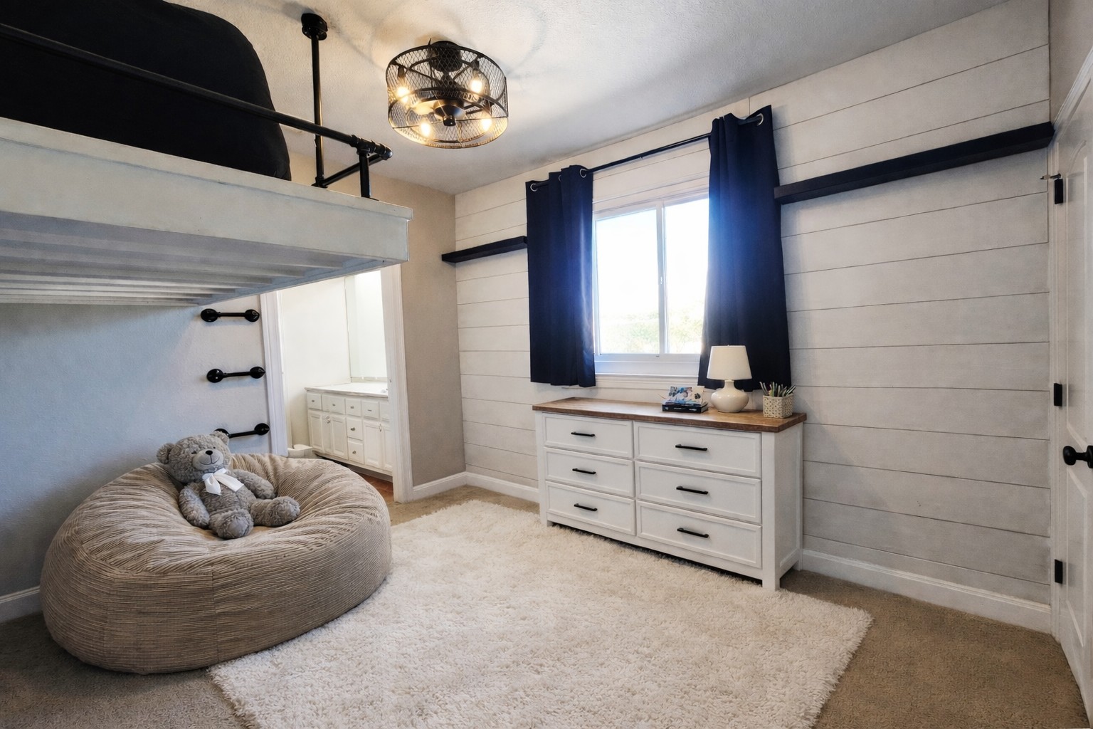 152 Silver Hawk Court Dripping Springs, TX 78620 - Photo 24 of 31 a spacious bedroom with a bed and a chandelier