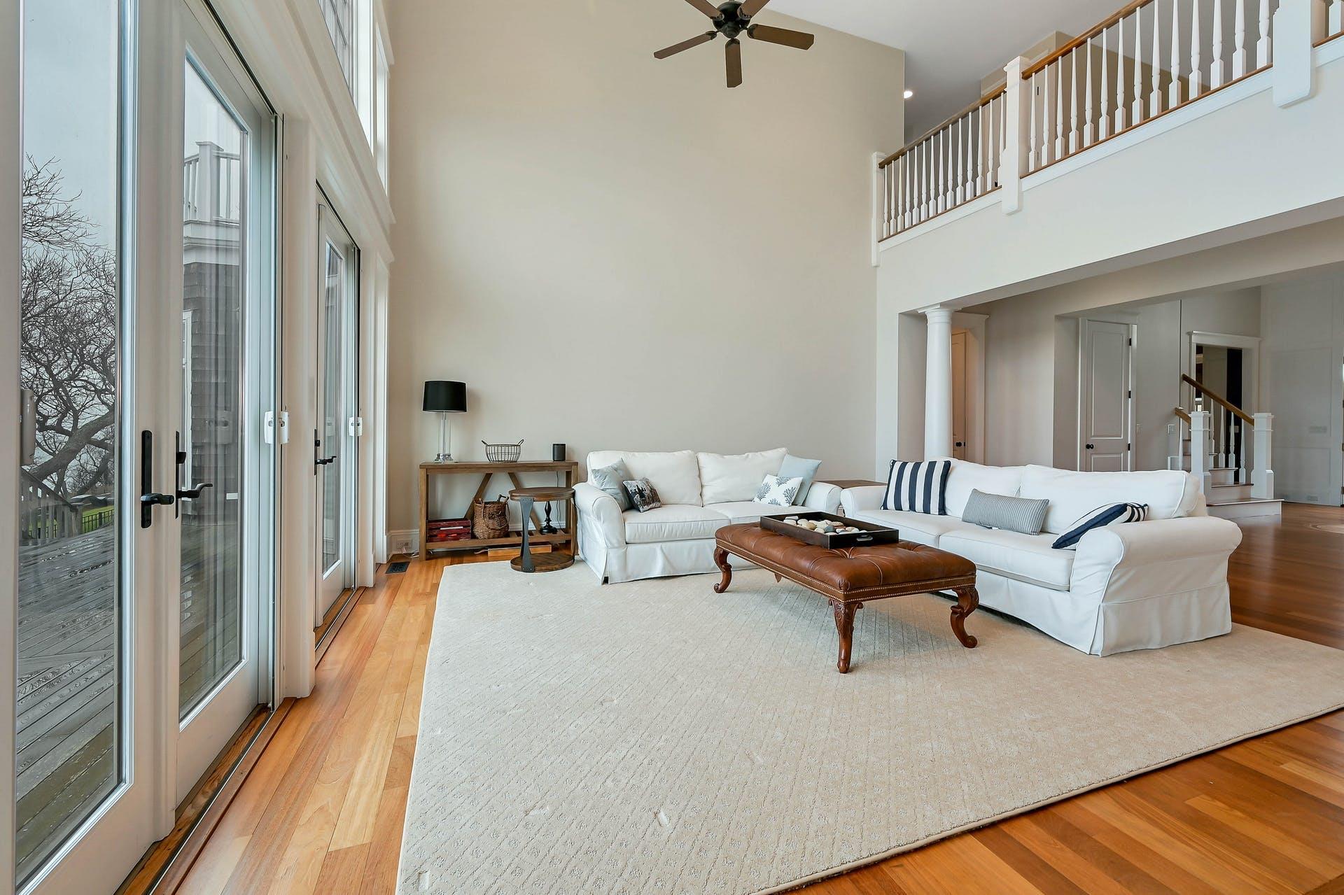 580 Lloyds Lane Mattituck, NY 11952 - Photo 11 of 30 Living room with ornate columns, ceiling fan, a towering ceiling, and light wood-type flooring