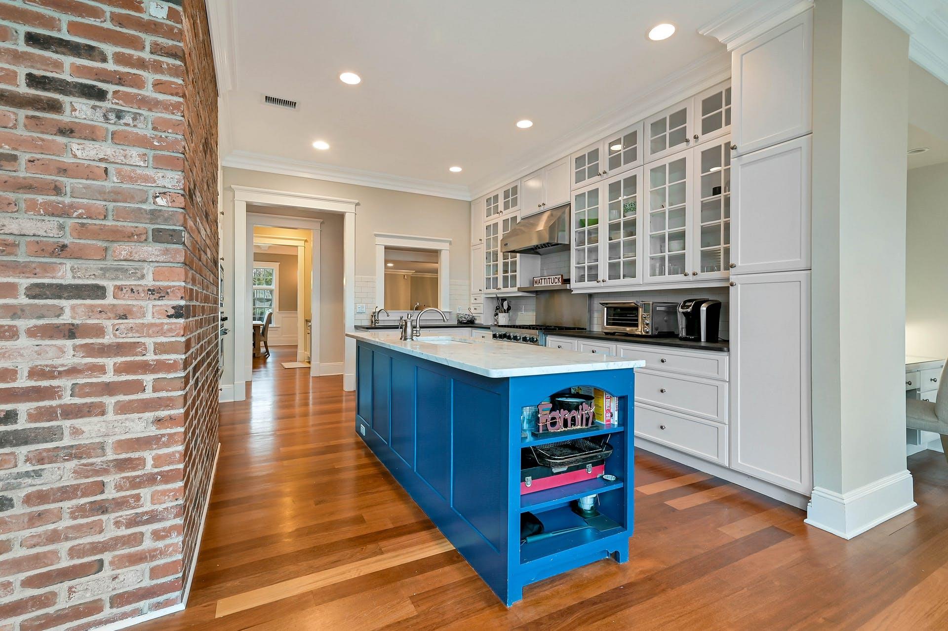 580 Lloyds Lane Mattituck, NY 11952 - Photo 12 of 30 Kitchen featuring sink, blue cabinetry, light hardwood / wood-style flooring, white cabinets, and an island with sink